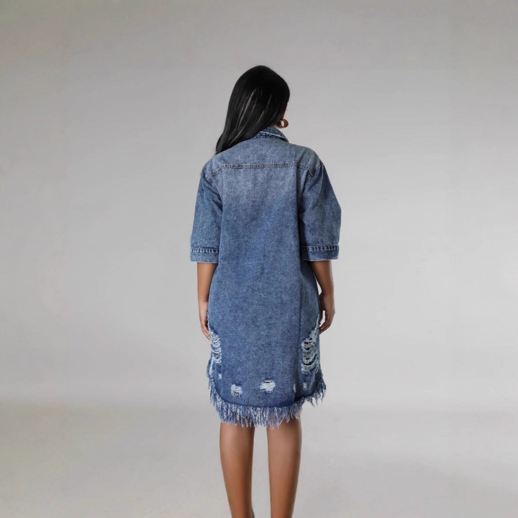 Denim jacket layered over a summer dress for fall