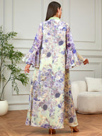 Woman wearing a floral dress in a room with a plant and sofa.